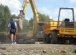 Digger digging out trench in preparation for foundations
