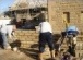 Bricklayers constructing stone boundary wall