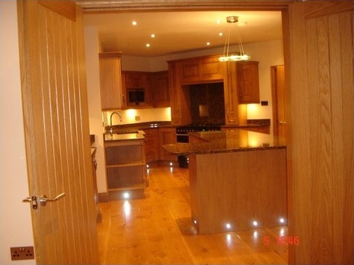 Solid oak doors leading on to the completed bespoke oak kitchen with feature contemporary lighting