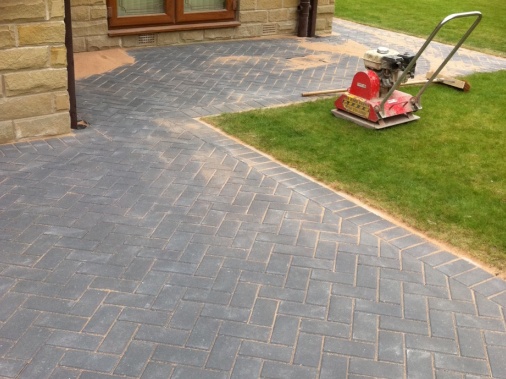 Kiln dried sand brushed into joints of block paving to strengthen bonding, then compressed