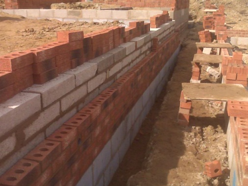 Strip foundation ready for block and beam floor with a red rustic splash course